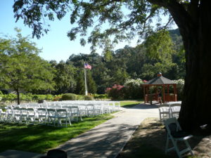 The oleanders in the background add a nice color to the ceremony while the flower professional adds the final touches.